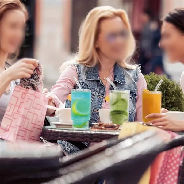 Clear cocktail glasses with lids and straws